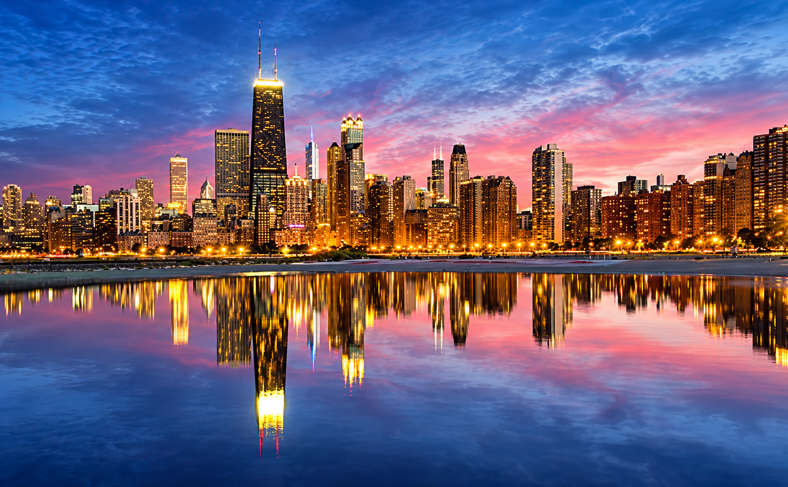 Chicago skyline at dusk reflected on the lake