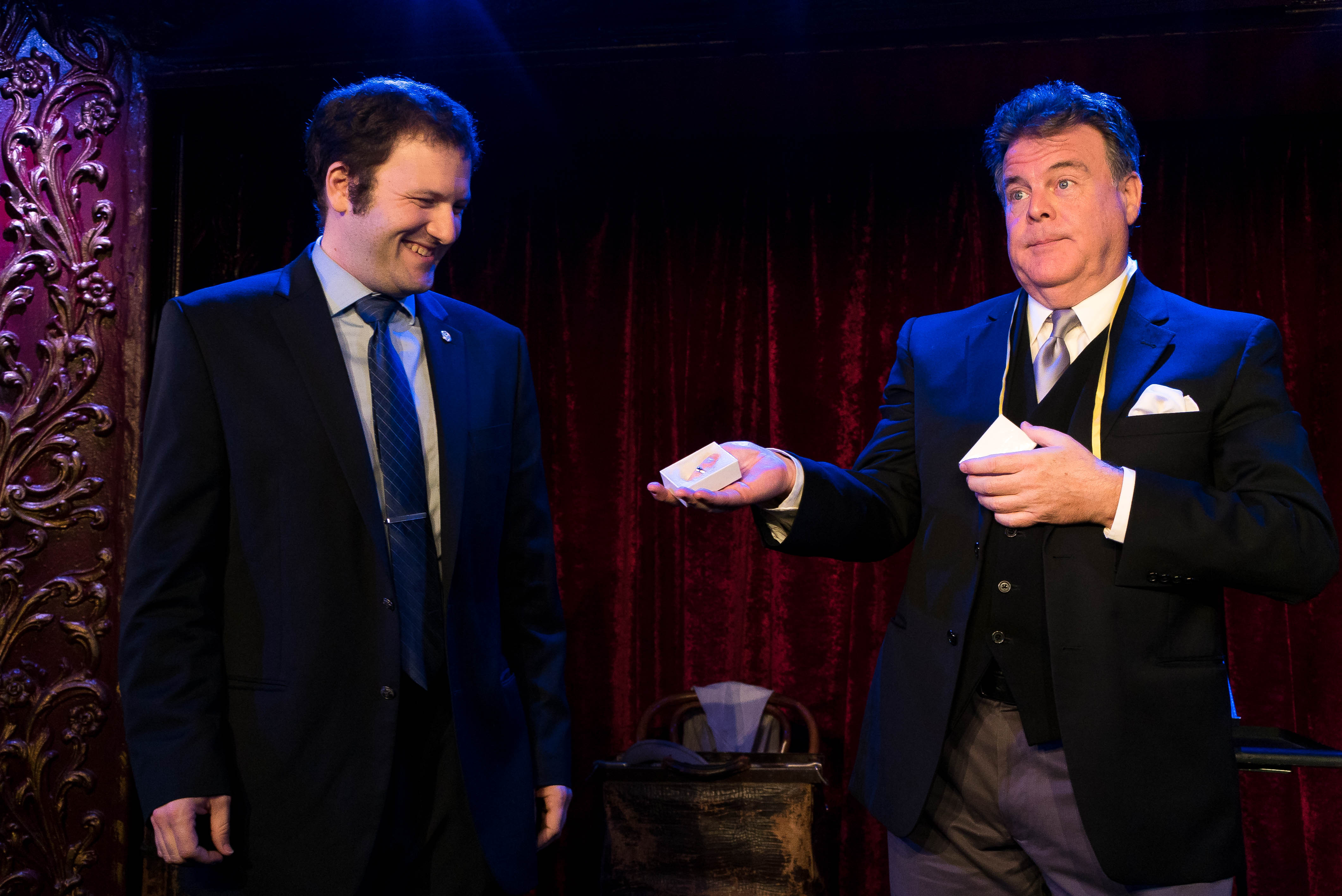 John Carney performing a card-and-glass illusion