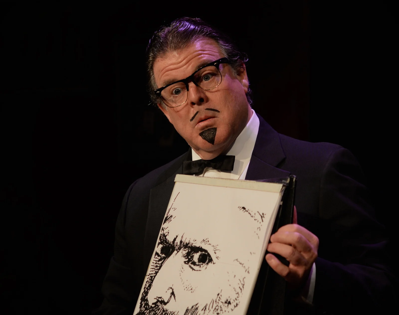 John in character holding a drawing of Van Gogh